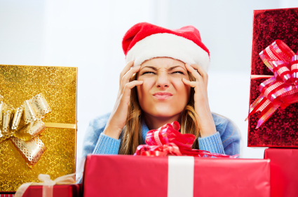 Worried woman surrounded by Christmas presents.